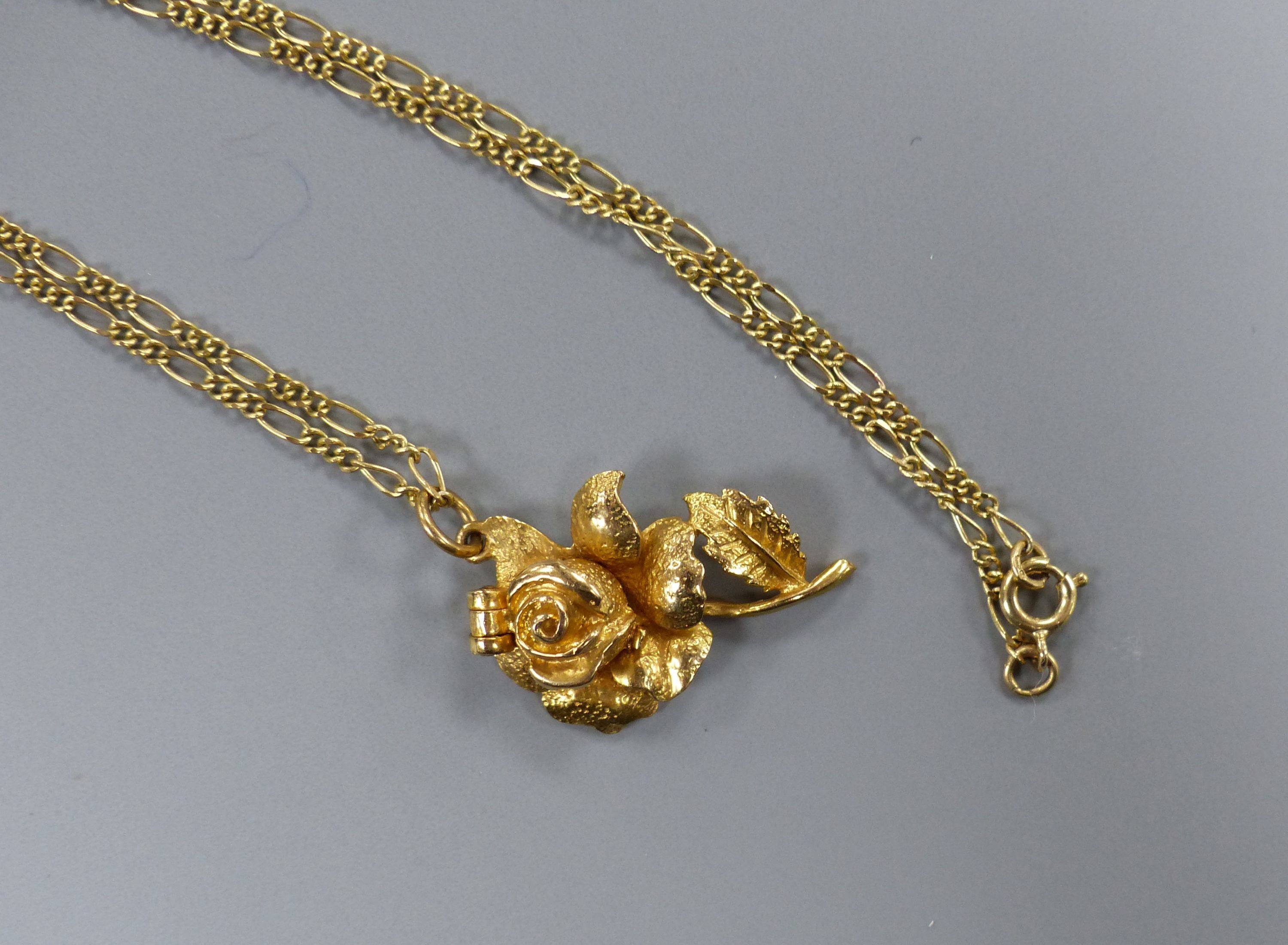 A modern 9ct gold rose pendant, 30mm, on a 9ct gold chain, 43cm,
